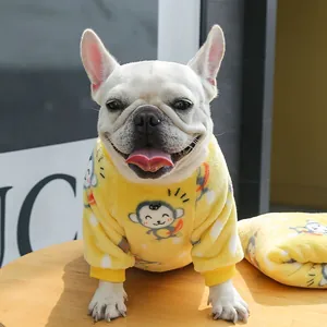 Detailed close-up of yellow fleece dog hoodie featuring cute monkey pattern and ribbed cuffs