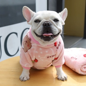 Detailed view of pink coral fleece dog pajamas with cute bear prints and matching blanket
