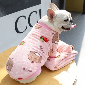 Close-up of pink fleece pet sweater with bear and strawberry prints on a French Bulldog