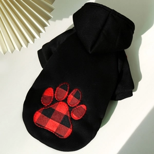 Detail of dog hoodie with buffalo plaid paw embroidery and ribbed cuffs for pet warmth