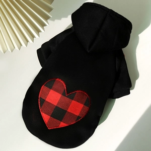 Detail view of a black dog hoodie featuring a red buffalo plaid heart applique on the back