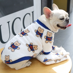 Close-up of warm white fleece pet sweater with blue ribbing and cute bear prints