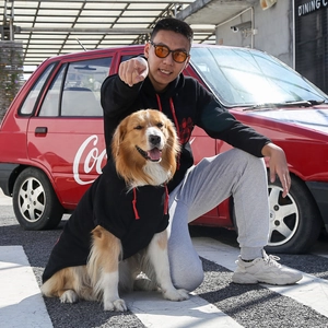 Detail of black matching hoodies with red paw prints for owners and golden retrievers