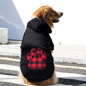Golden Retriever wearing black pet hoodie with red plaid heart-shaped paw print design