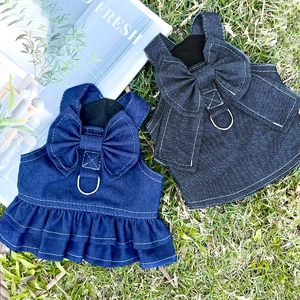 Detail of blue denim pet dresses with bow accent, D-ring, and ruffled skirt layers