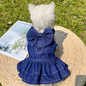 Close-up of a blue denim pet dress with a large bow and metal D-ring on the back