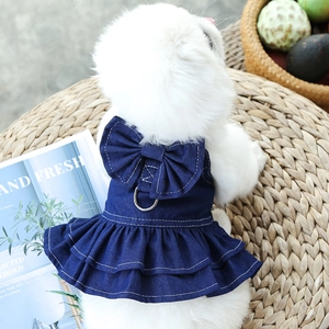 Close-up of denim pet dress with large bow and metal D-ring for leash attachment