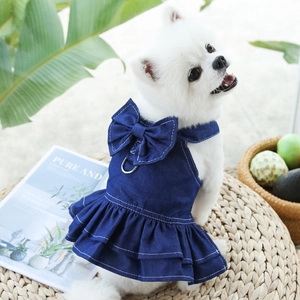 Detail of blue denim pet dress featuring a large bow and metal D-ring for leash attachment