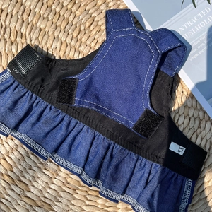 Detailed macro view of small pet denim skirt with adjustable Velcro and ruffle hem design