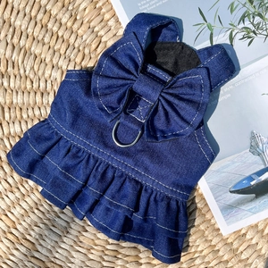 Detail of denim dog harness dress featuring a metal D-ring and large bow on the back