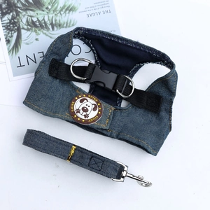 Dettaglio dell'imbracatura in denim blu scuro con stemma SHINE e anello a D in metallo