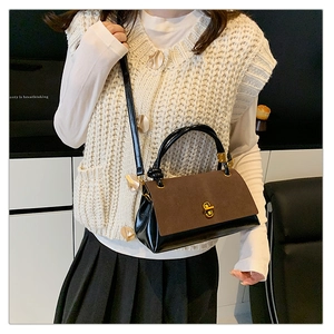Detail of vintage contrast suede and leather crossbody bag with golden hardware