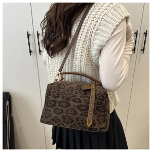 Détail du sac docteur léopard en daim avec bandoulière en cuir et rivets métalliques