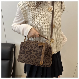 Détail du sac à bandoulière vintage en daim avec motif léopard et garnitures dorées