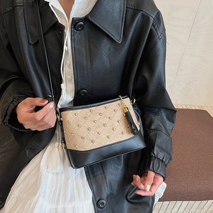 Quilted crossbody hobo bag with beige suede texture and rhinestone accents on black base