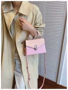 Detail of pink snake-pattern flap and silver buckle on chic luxury crossbody handbag
