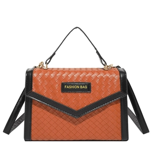 Women's woven straw textured crossbody bag in orange and black with gold hardware