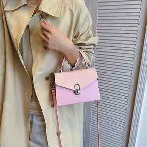 Pink snakeskin patchwork handbag with metal lock shown as a stylish crossbody bag