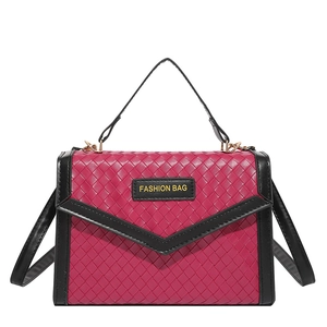 Fashionable red woven crossbody bag with black trim and elegant top handle detail