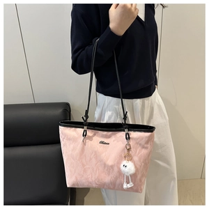 Pink marbled tote bag detail with slim black leather straps and a plush white charm