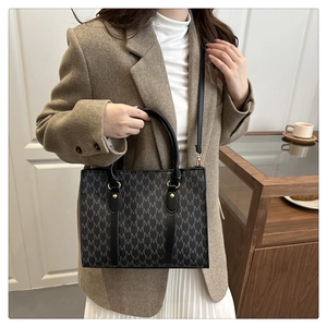 Fashionable monogram crossbody bag styled with a brown blazer and white skirt