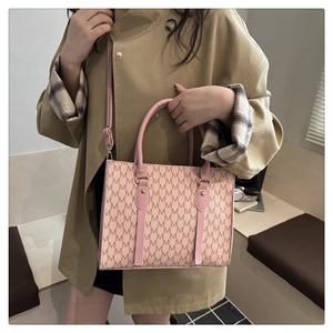 Detail of pink M-letter printed tote bag with adjustable strap and gold-tone hardware