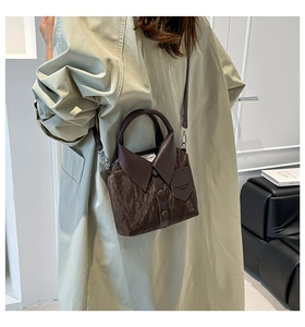 Fashionable coffee brown handbag with unique shirt collar design worn by a model