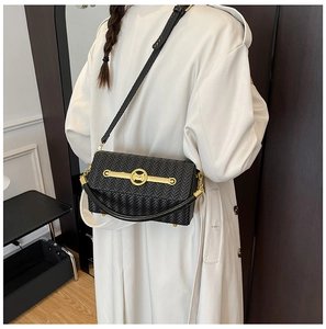 Detailed view of black woven texture crossbody bag with gold metal M letter buckle and strap