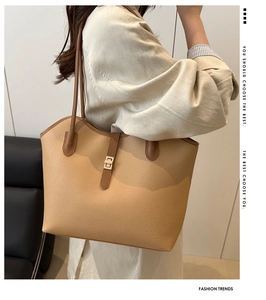 Detailed shot of a brown lychee pattern tote bag with a metal twist lock and shoulder strap