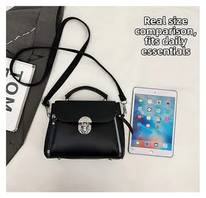 Capacity view of black litchi grain handbag with silver clasp compared to an iPad