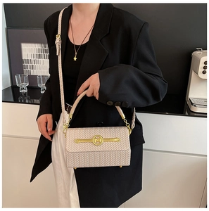 Detailed view of beige woven texture handbag featuring a gold M logo buckle and leather strap