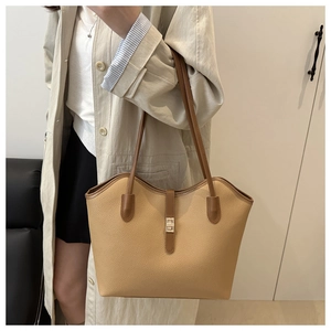 Detailed view of beige lychee pattern tote bag with brown straps and silver metal buckle