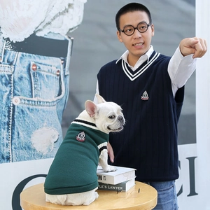 Matching preppy style pet and owner knit vests with shield embroidery details