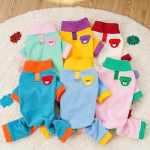Detailed view of colorful fleece pet jumpsuits with D-ring harness and bear embroidery