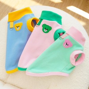 Close-up of fleece dog vests in various colors with metal D-rings and bear embroidery
