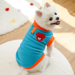 Detail of blue fleece pet vest featuring an orange trim and metal D-ring for leash attachment