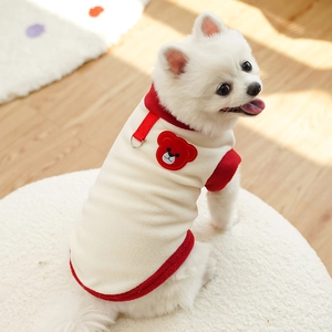Close-up of warm fleece pet vest with cute cartoon bear patch and red leash D-ring