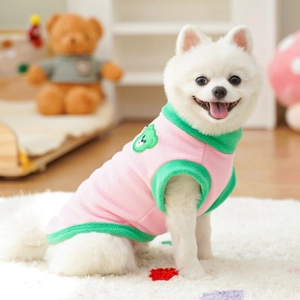 Detail of pink and green fleece pet vest with cute cartoon bear embroidery on dog