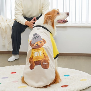 Detail of pet fleece hoodie with teddy bear print on a golden retriever in cozy home