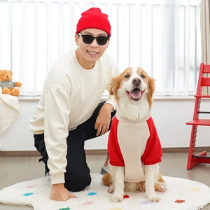 Cozy matching owner and dog hoodies in red and cream for a warm indoor lifestyle