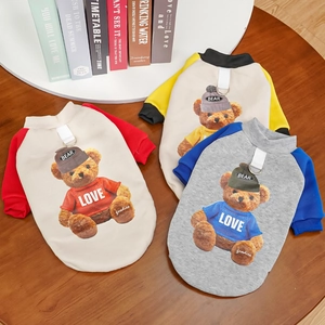 Three colorful knitted pet sweaters with teddy bear patterns and leash D-rings
