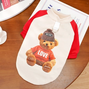 Detail of red and white pet hoodie with teddy bear print and metal D-ring for leash