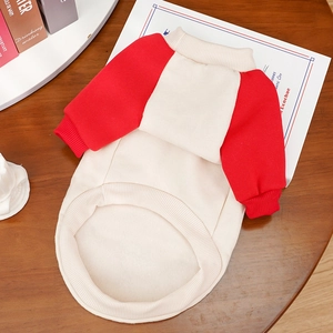 Detail view of contrast sleeve pet sweatshirt with ribbed cuffs on dark wood surface
