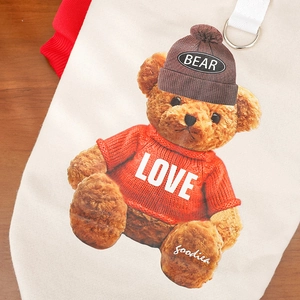 Detail of pet fleece hoodie featuring a teddy bear print and metal D-ring attachment