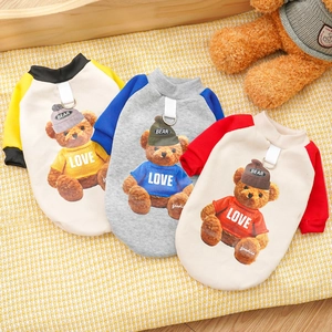Close-up of three fleece dog hoodies with teddy bear prints and metal leash D-rings
