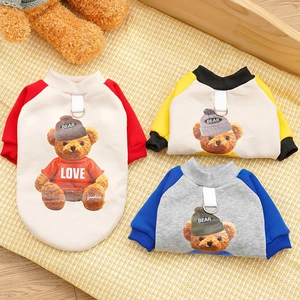 Detail of colorful pet hoodies featuring bear prints and metal D-rings for leash attachment