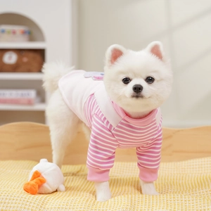 Close-up of pink and white striped pet sweater with cute cartoon patch on soft fabric