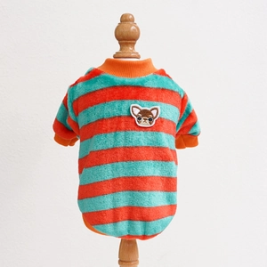 Detail of plush orange and blue striped pet sweater with dog embroidery on wood model