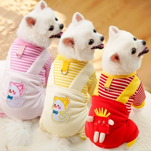 Close-up of three dogs wearing colorful pet jumpsuits with cartoon patches and leash D-rings