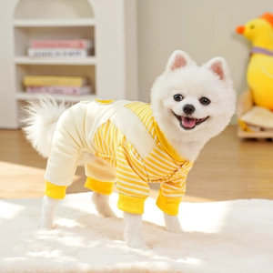 Detail of yellow striped dog jumpsuit with cartoon embroidery and ribbed cuffs for warmth